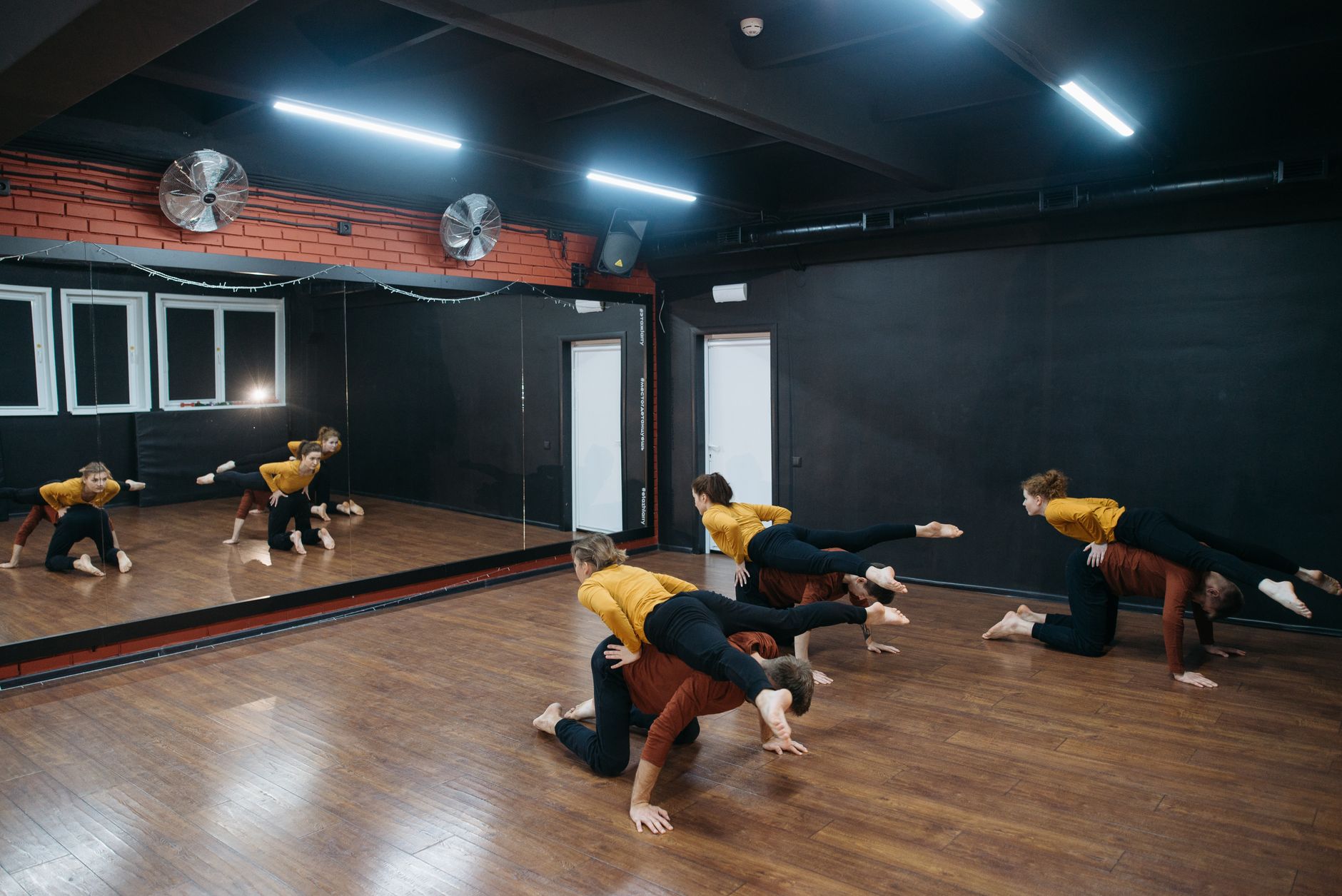 K-pop trainees rehearsing choreography in a dance studio