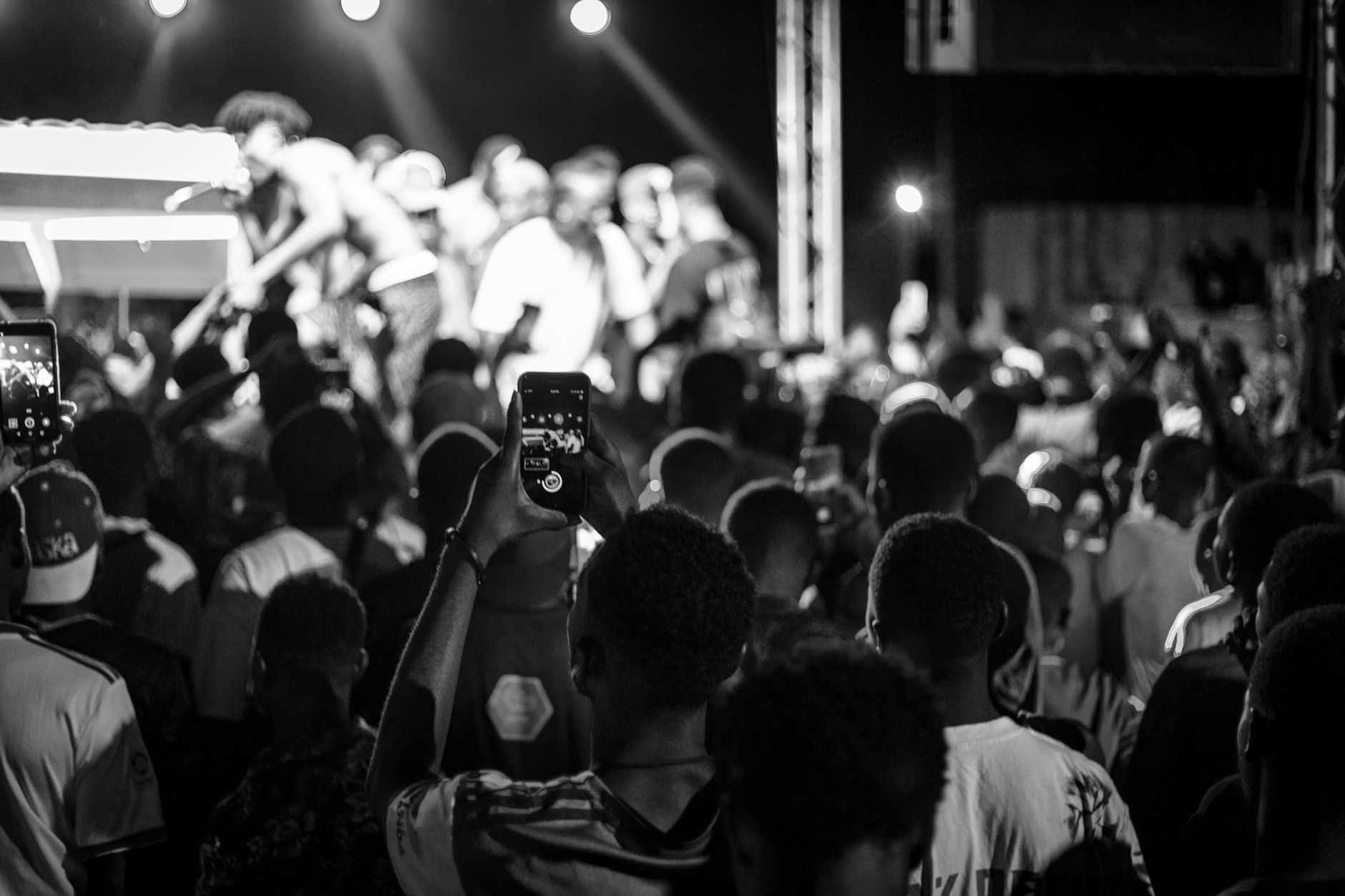 Concert crowd holding up phones during an album release show