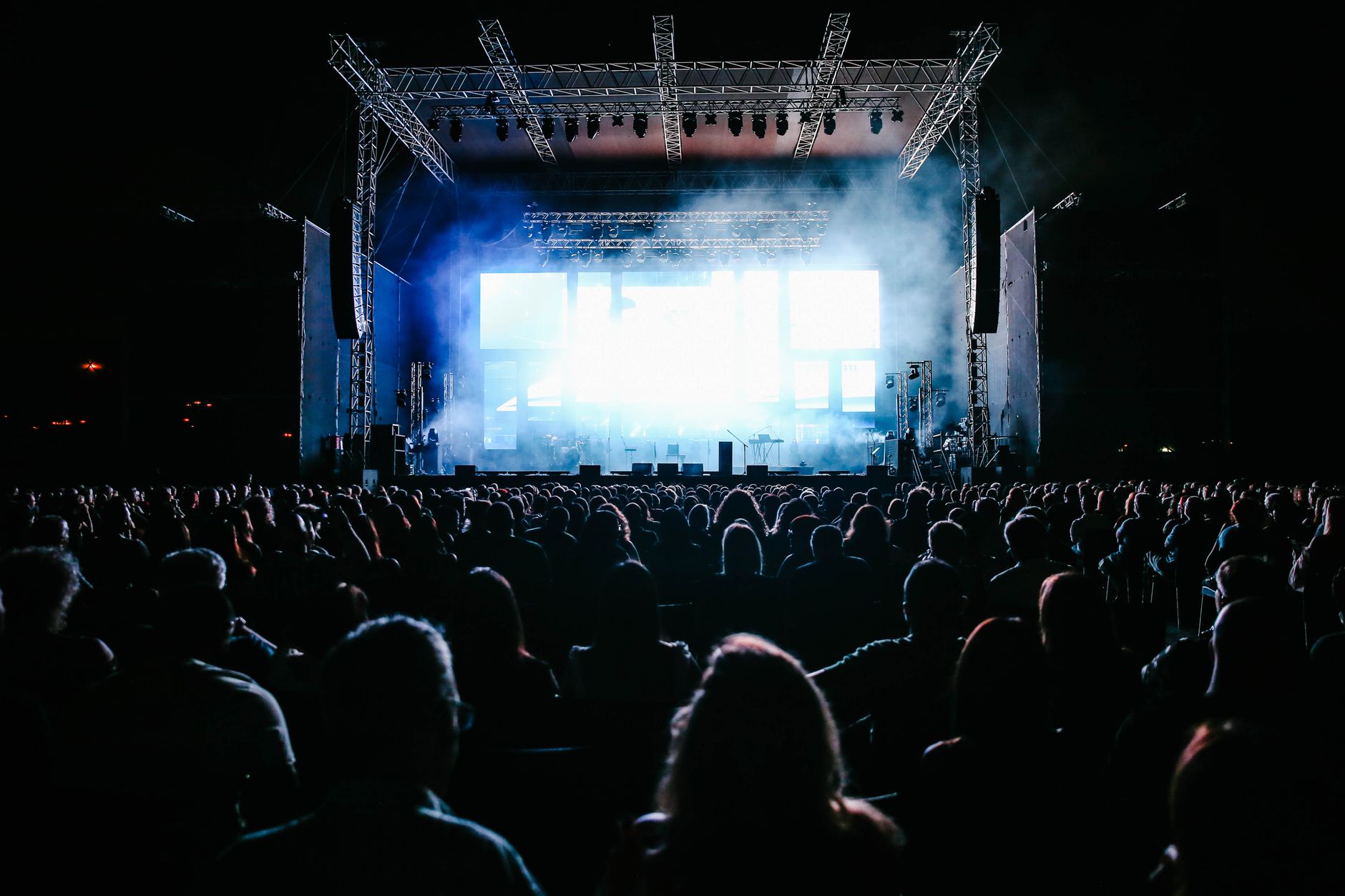 Sold out arena crowd at a concert with stage lights